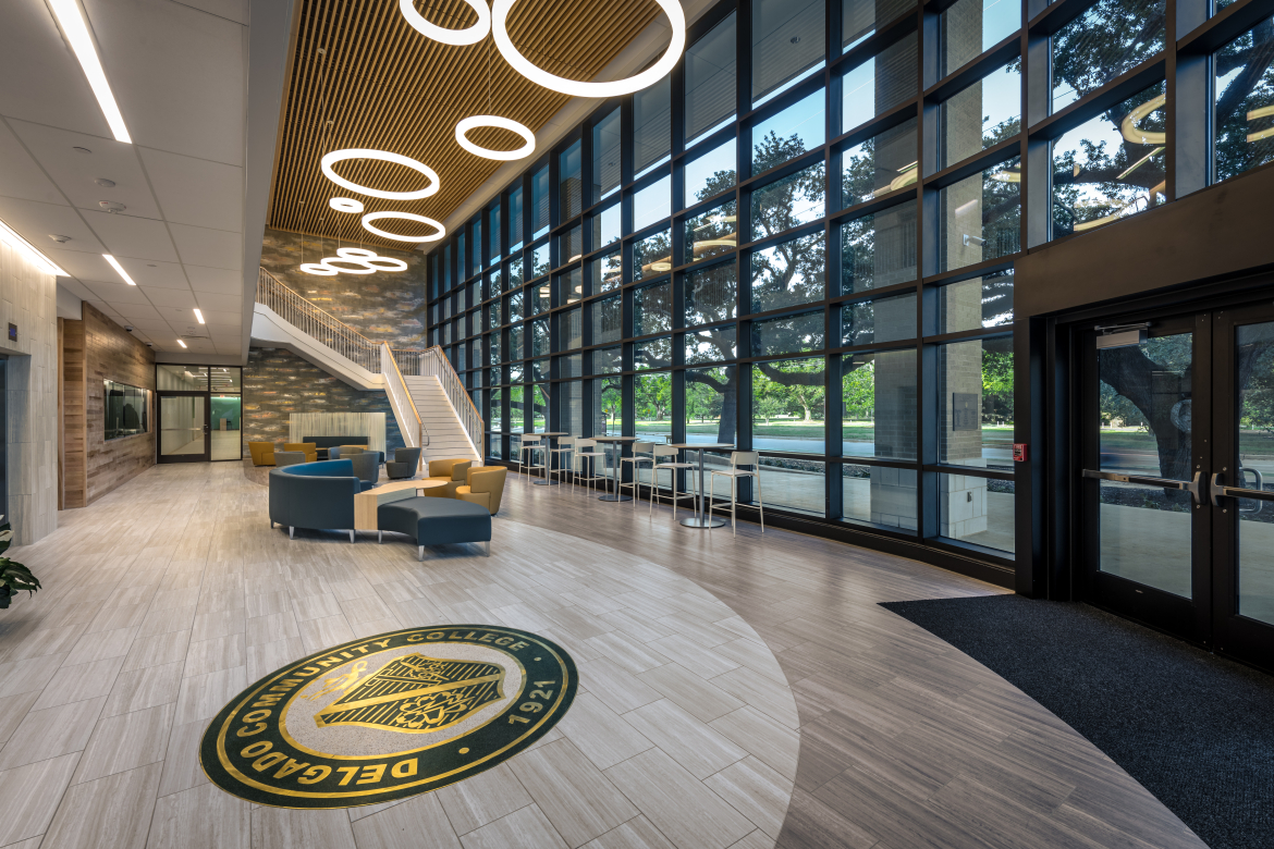 Lobby of a building with large windows and a seating area.